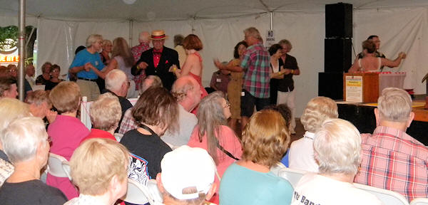 Full chairs in tent and busy dance floor