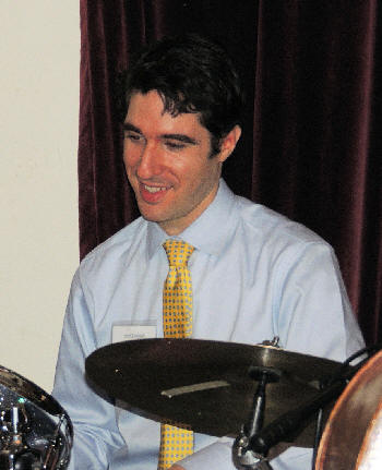 Kevin Dorn sitting at drums and smiling