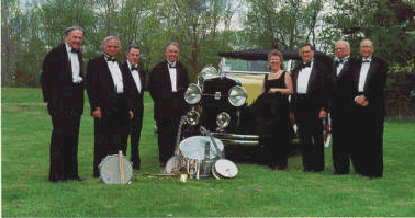 band in tuxedos with old convertible car