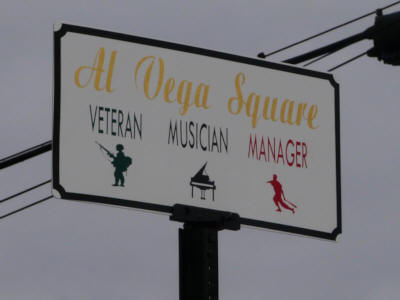 Sign that says
		Al Vega Square, Veteran, Musician, Manager