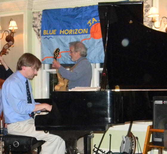 Ross playing piano, Peter Gerler on guitar behind him