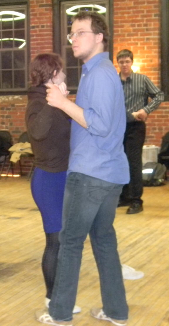 Kate and Carl teaching swing dance with my grandson looking on