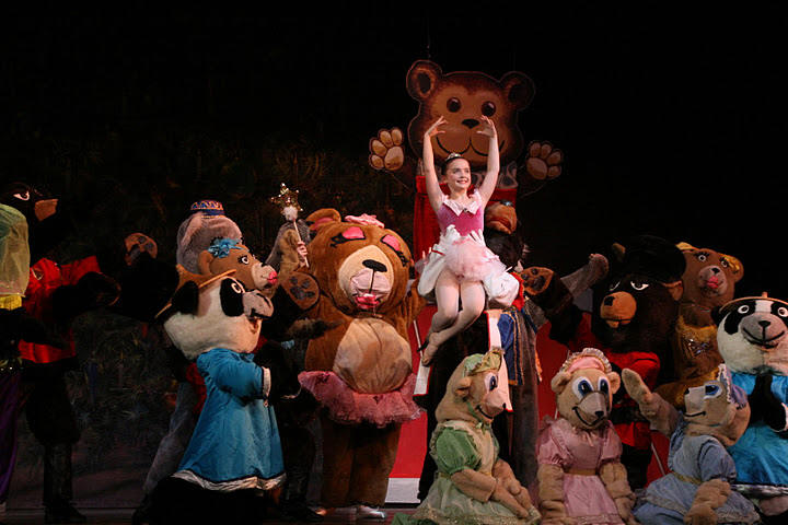 Russian Bears, Mice, Chinese Pandas, and balerina Brianna Maguire being held up by a bear