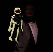 Kermit, the frog, being held by Buddy Bergeron in the background