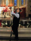 John Chan in front of the altar, taking pictures