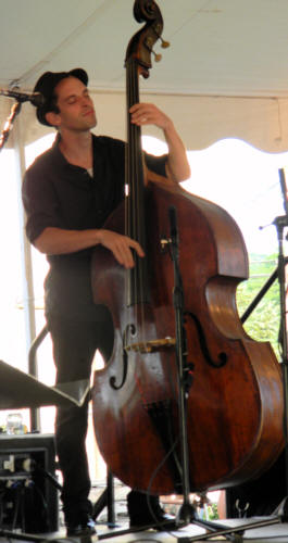 the bass player, his eyes closed, playing with feeling,