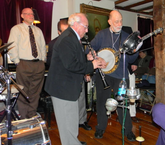 Noel K. clarinet, Joel S. banjo, Jeff Barnhart standing with hands in his pocket, watching them with pride