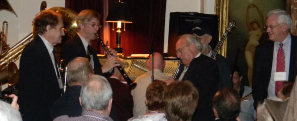 Joe and Noel face-off on clarinet, being watched by Herb, Craig, and fans