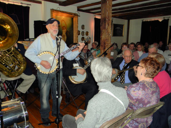 Joel singing, Vince, Barta, Noel on banjo behind him