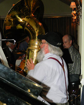 Al Bernard, with long white hair and beard, on tuba