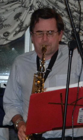 Clark grimacing as he strains on alto sax