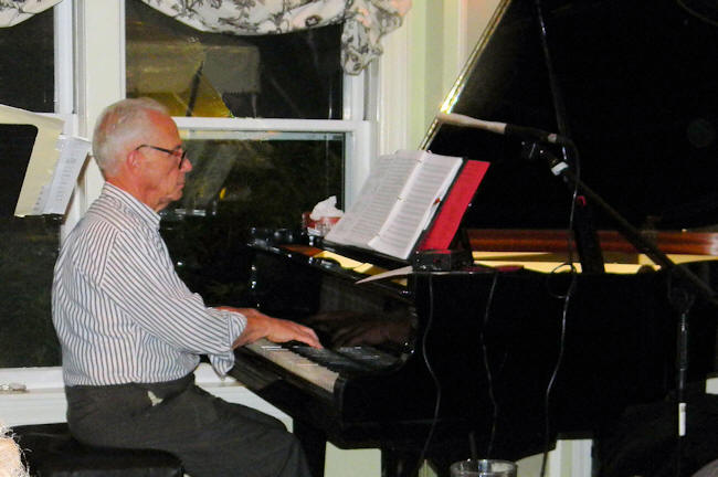 a very serious Robin at the baby grand piano