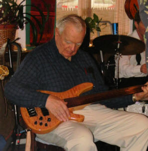 McHenry sitting with bass guitar