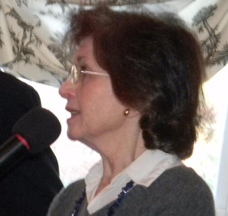 side view of Ellen McDonald talking into a mic