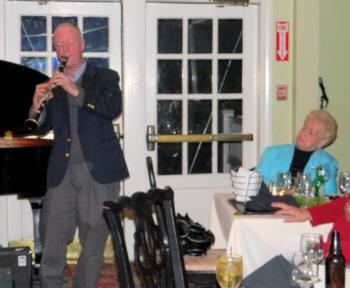 Craig playing clarinet while Lynn looks on